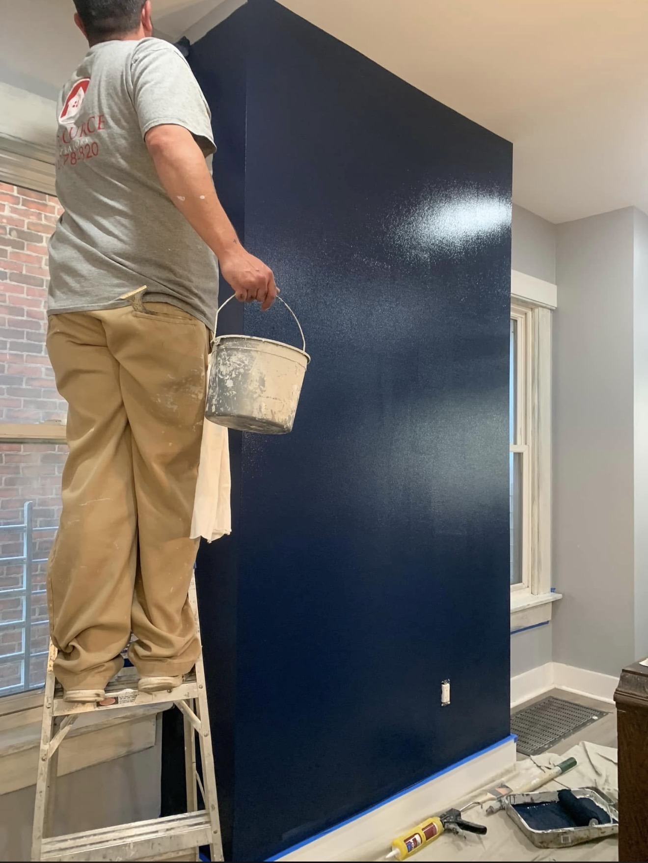Navy accent wall being painted